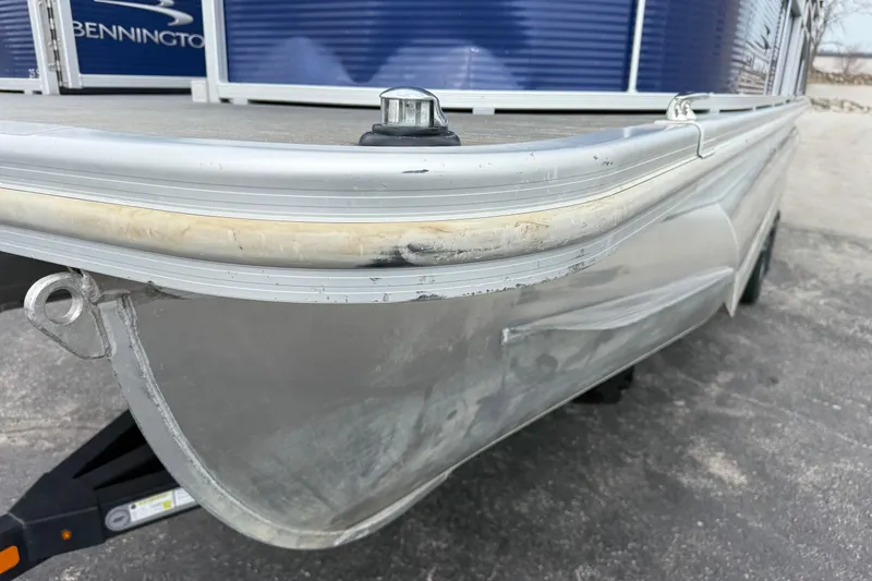 Slide: The Image of 2023 Bennington 25ssrc pontoon boat with visible wear on the aluminum hull. - 29
