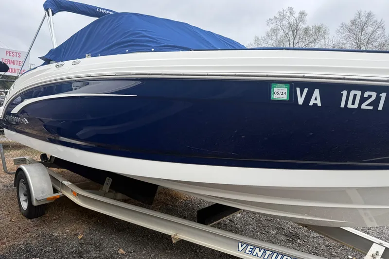 Slide: The Image of 2014 Chaparral 226 SSi boat on trailer, covered with blue tarp. - 1