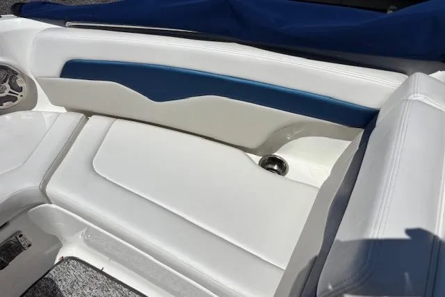 Slide: The Image of Interior seating of a 2014 Chaparral 226 SSi boat with white and blue upholstery. - 19