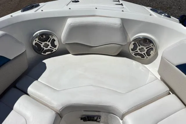 Slide: The Image of 2014 Chaparral 226 SSi boat interior with white seating and built-in speakers. - 20