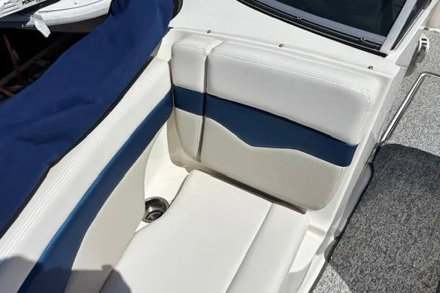 Slide: The Image of 2014 Chaparral 226 SSi boat interior with white and blue seating. - 21