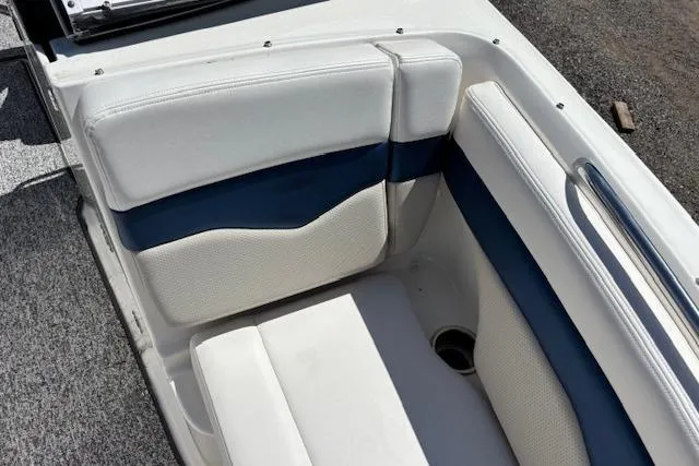 Slide: The Image of 2014 Chaparral 226 SSi boat interior with white and blue cushioned seating. - 22