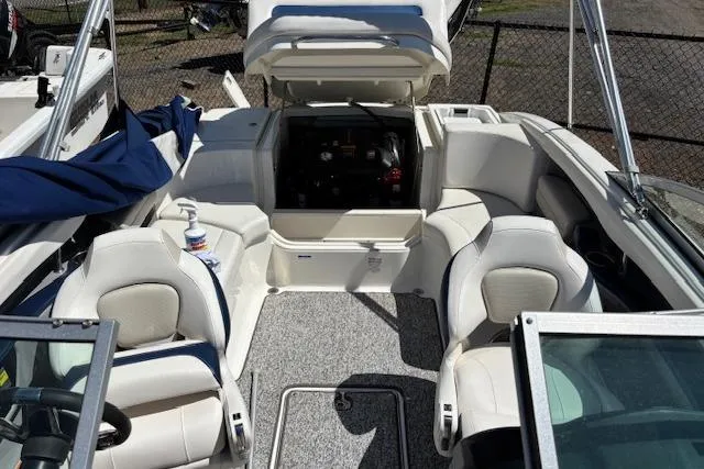 Slide: The Image of 2014 Chaparral 226 SSi boat interior with open engine compartment and white seating. - 23