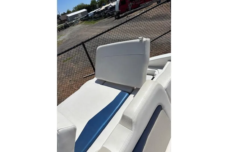 Slide: The Image of 2014 Chaparral 226 SSi boat interior with white and blue seating, outdoor setting. - 24