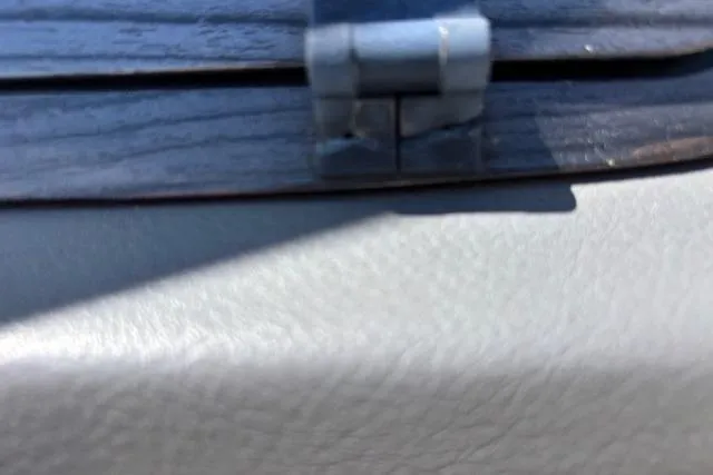 Slide: The Image of Close-up of a hinge on a 2014 Chaparral 226 SSi boat interior. - 28