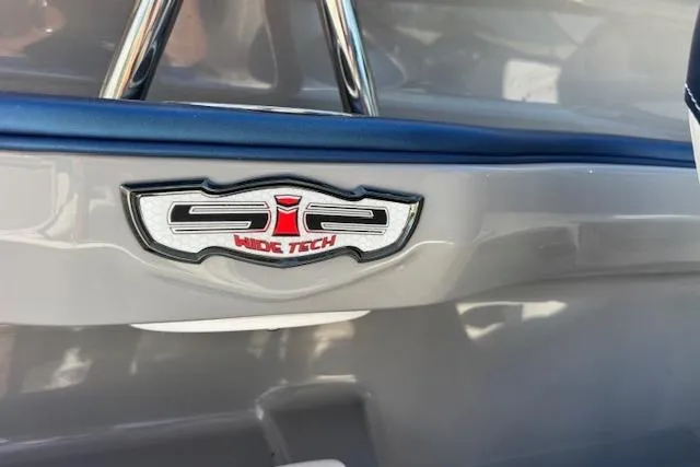 Slide: The Image of 2014 Chaparral 226 SSi boat emblem with "Wide Tech" branding on a sleek gray surface. - 30
