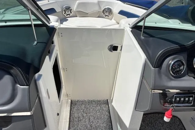Slide: The Image of 2014 Chaparral 226 SSi boat interior with open door and dashboard view. - 34