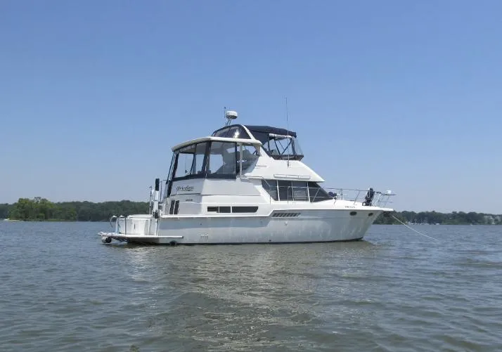 Slide: The Image of 1997 Carver 400 Cockpit Motor Yacht on calm waters. - 0