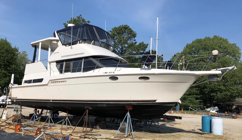 Slide: The Image of 1997 Carver 400 Cockpit Motor Yacht on land, side view. - 1