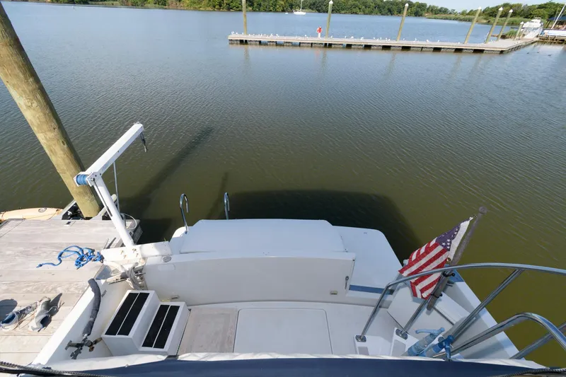 Slide: The Image of 1997 Carver 400 Cockpit Motor Yacht docked with water view. - 10