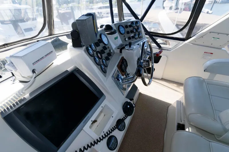 Slide: The Image of Interior view of 1997 Carver 400 Cockpit Motor Yacht helm. - 14