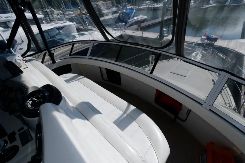 Slide: The Image of Interior of a 1997 Carver 400 Cockpit Motor Yacht in harbor. - 16