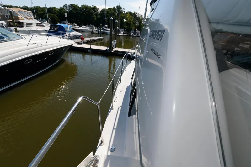Slide: The Image of 1997 Carver 400 Cockpit Motor Yacht docked at marina. - 17