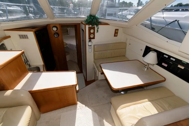 Slide: The Image of Interior of 1997 Carver 400 Cockpit Motor Yacht with seating area and table. - 22