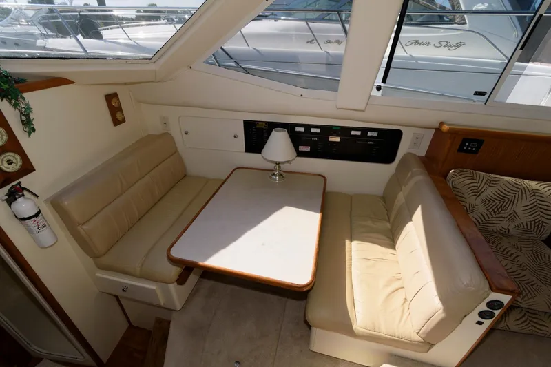 Slide: The Image of Interior of 1997 Carver 400 Cockpit Motor Yacht with seating area. - 23