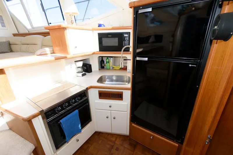 Slide: The Image of 1997 Carver 400 Cockpit Motor Yacht kitchen with appliances. - 25