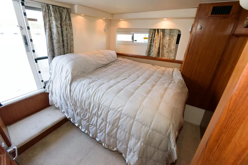 Slide: The Image of Interior of 1997 Carver 400 Cockpit Motor Yacht with cozy bed. - 26
