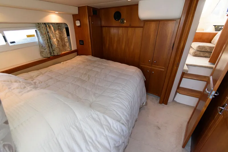 Slide: The Image of Interior of 1997 Carver 400 Cockpit Motor Yacht featuring cozy bedroom. - 27