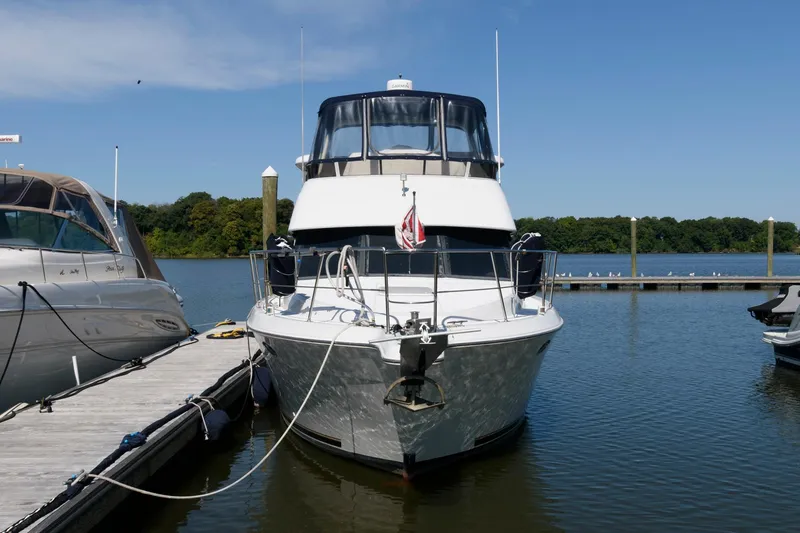 Slide: The Image of 1997 Carver 400 Cockpit Motor Yacht docked at marina. - 3