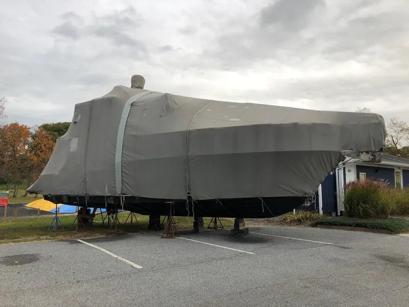 Slide: The Image of 1997 Carver 400 Cockpit Motor Yacht covered and parked outdoors. - 4