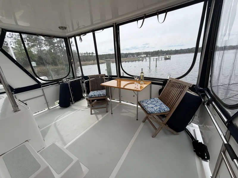 Slide: The Image of Interior of 2002 Heritage East 36 Sundeck yacht with table and chairs. - 14