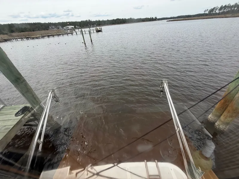 Slide: The Image of View from a Heritage East 36 Sundeck boat overlooking calm waters. - 15