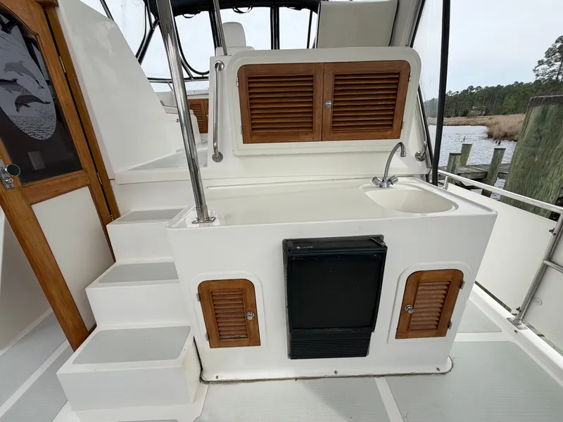 Slide: The Image of 2002 Heritage East 36 Sundeck with outdoor kitchenette and wooden accents. - 16