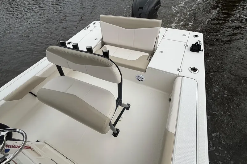 Slide: The Image of 2017 Robalo 246 Cayman boat interior with seating and fishing rod holders. - 13