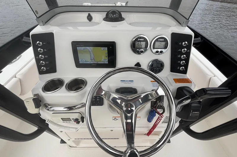Slide: The Image of 2017 Robalo 246 Cayman boat dashboard with steering wheel, GPS, and controls. - 9