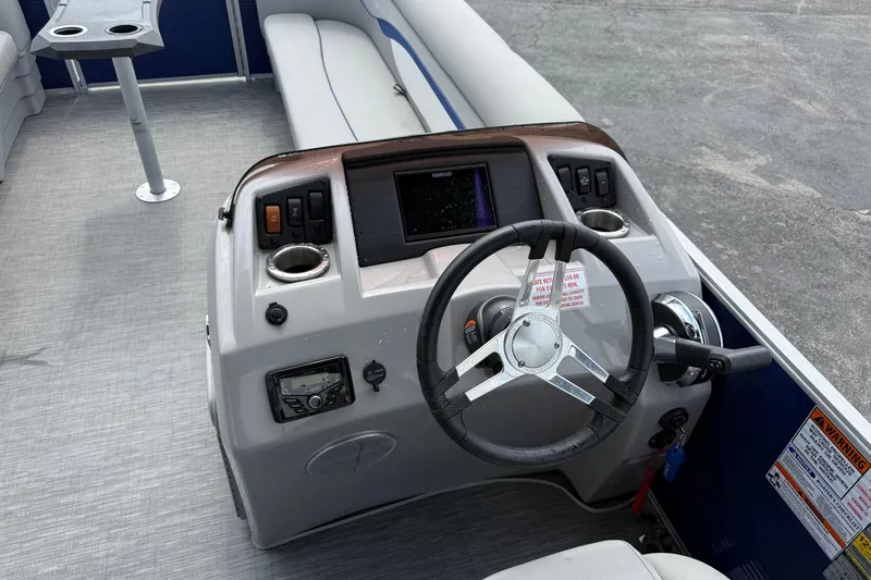 Slide: The Image of 2023 Bennington 24SSRC boat dashboard with steering wheel and control panel. - 20