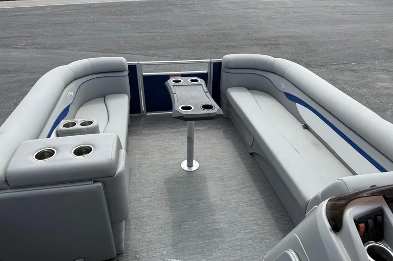 Slide: The Image of 2023 Bennington 24SSRC pontoon boat interior with gray seating and cup holders. - 22