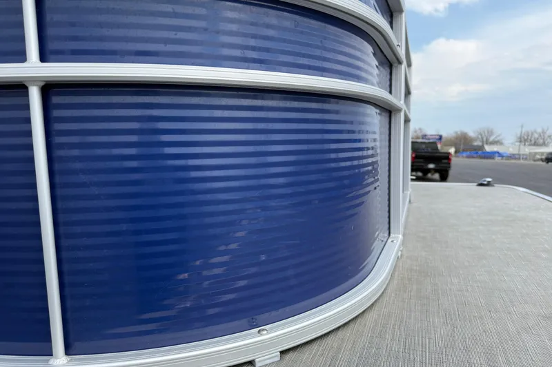 Slide: The Image of Close-up of 2023 Bennington 24SSRC pontoon boat's blue exterior with aluminum railing. - 26