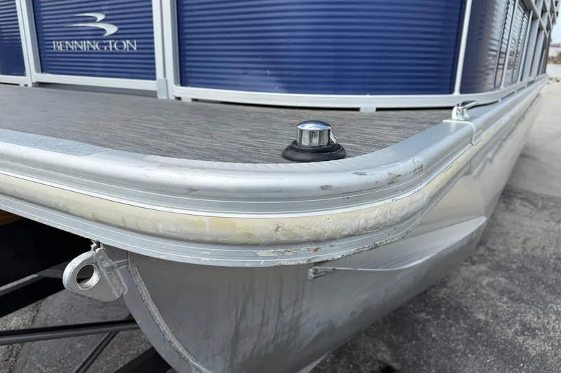 Slide: The Image of 2023 Bennington 24SSRC pontoon boat, close-up of bow and railing details. - 29