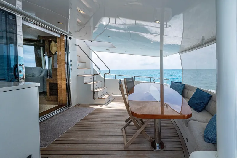 Slide: The Image of Luxurious 2018 Cheoy Lee Bravo 78 yacht deck with seating, table, and ocean view. - 26