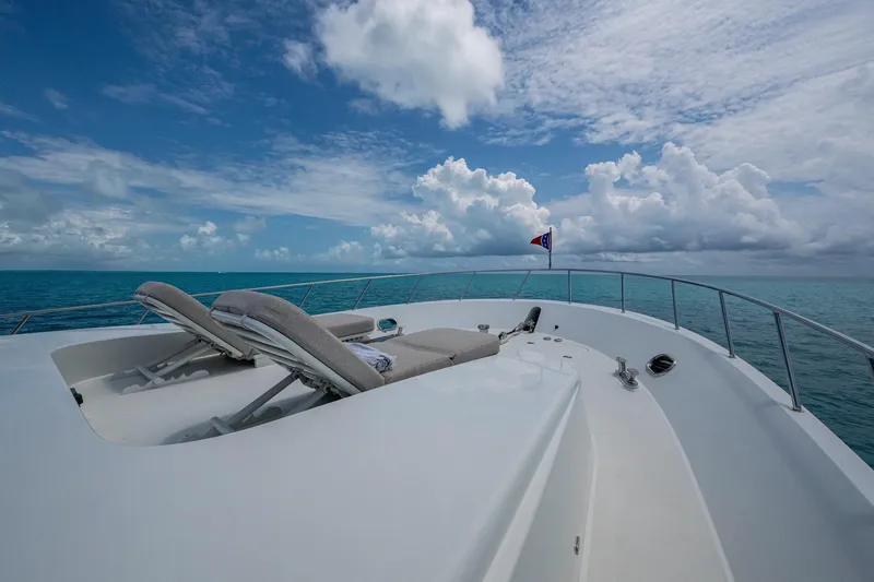 Slide: The Image of Luxurious 2018 Cheoy Lee Bravo 78 yacht deck with lounge chairs under a vibrant sky. - 33