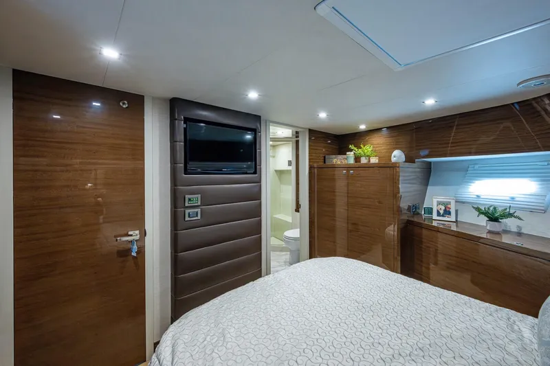 Slide: The Image of Luxurious 2018 Cheoy Lee Bravo 78 yacht bedroom with modern decor and elegant wood finishes. - 76