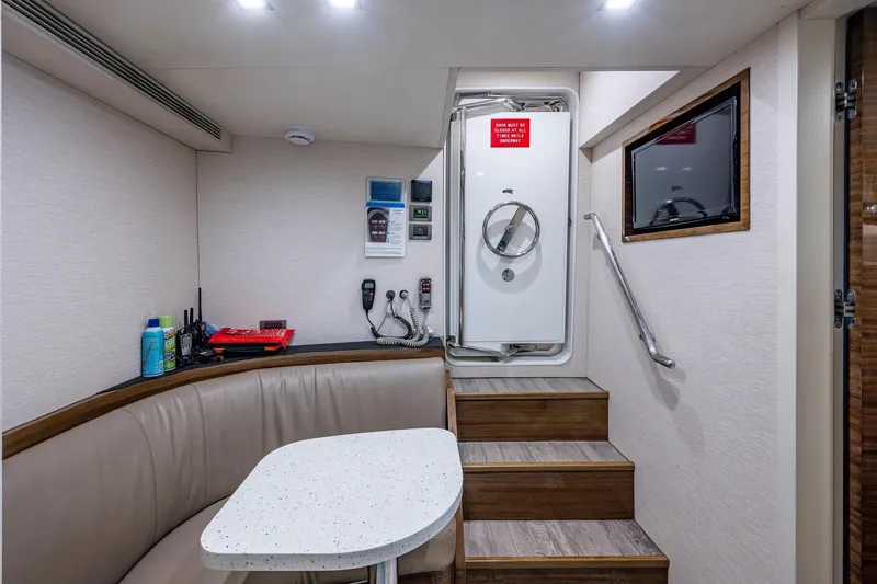 Slide: The Image of Interior of 2018 Cheoy Lee Bravo 78 Sport Motor Yacht with seating and control panel. - 78