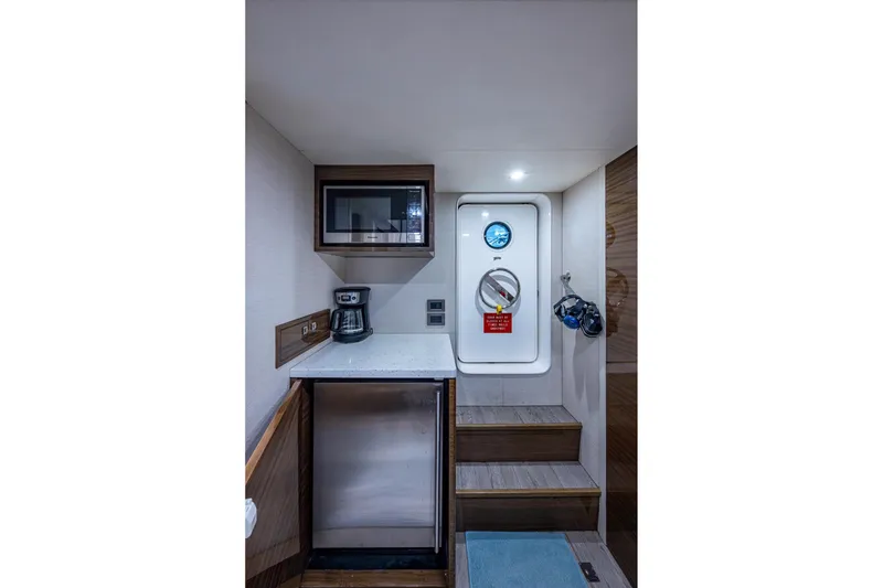 Slide: The Image of 2018 Cheoy Lee Bravo 78 Sport Motor Yacht interior with kitchenette and access door. - 79