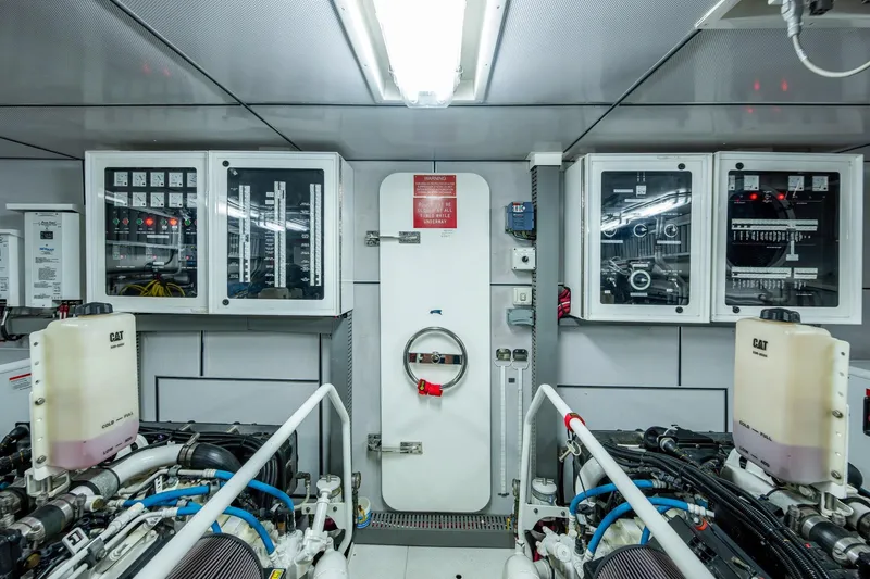 Slide: The Image of Engine room of 2018 Cheoy Lee Bravo 78 Sport Motor Yacht, featuring control panels and machinery. - 87