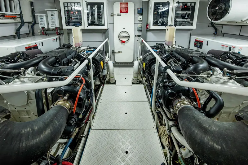Slide: The Image of Engine room of 2018 Cheoy Lee Bravo 78 Sport Motor Yacht, showcasing dual engines and control panels. - 88