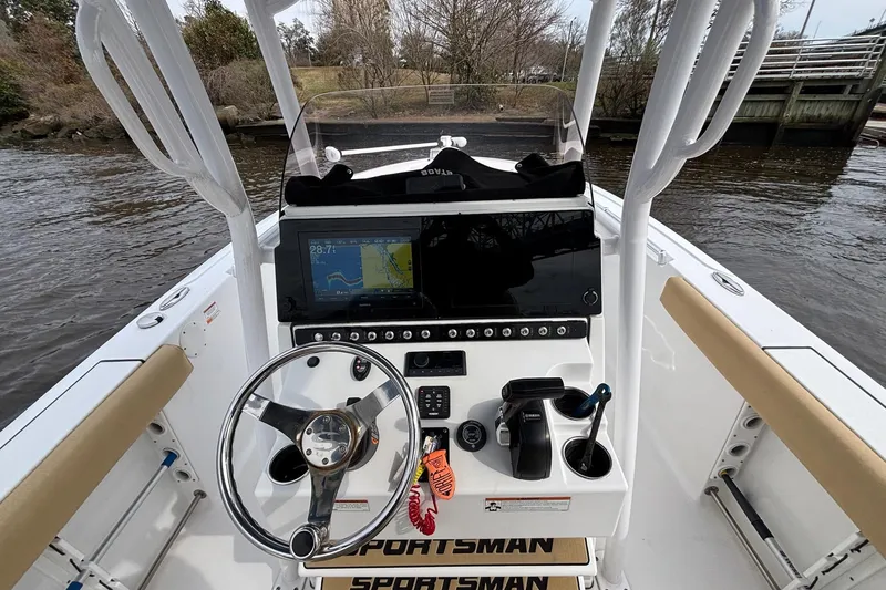 Slide: The Image of 2022 Sportsman Open 242 Center Console boat dashboard with navigation system and steering wheel. - 11