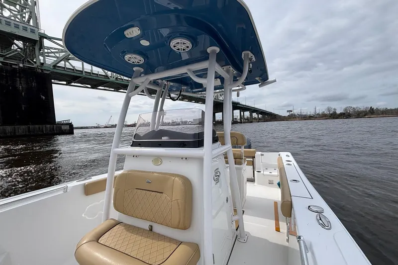 Slide: The Image of 2022 Sportsman Open 242 Center Console boat on a river near a bridge. - 12