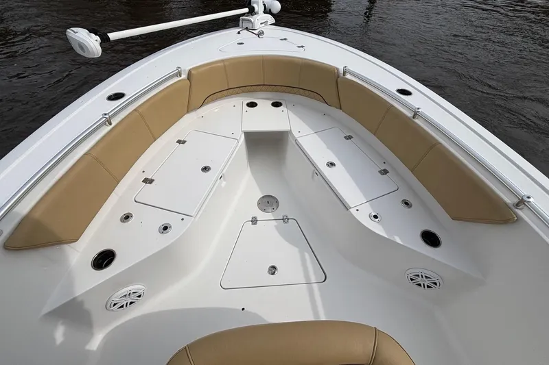 Slide: The Image of 2022 Sportsman Open 242 Center Console boat interior with tan seating and storage compartments. - 15