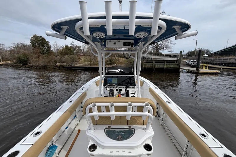 Slide: The Image of 2022 Sportsman Open 242 Center Console boat docked by a riverside. - 17