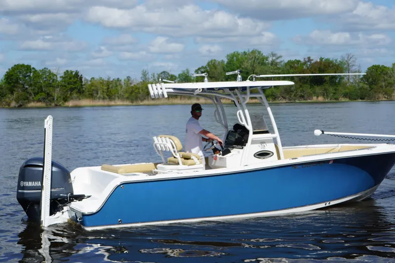 Slide: The Image of 2022 Sportsman Open 242 Center Console boat on calm water, featuring a Yamaha engine. - 18