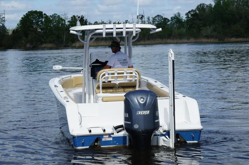 Slide: The Image of 2022 Sportsman Open 242 Center Console boat on calm water, rear view. - 3