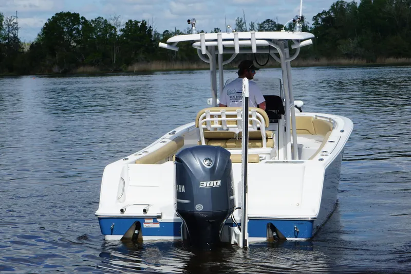 Slide: The Image of 2022 Sportsman Open 242 Center Console boat on calm water, rear view. - 4