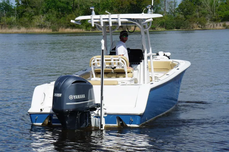 Slide: The Image of 2022 Sportsman Open 242 Center Console boat on water with Yamaha engine. - 7