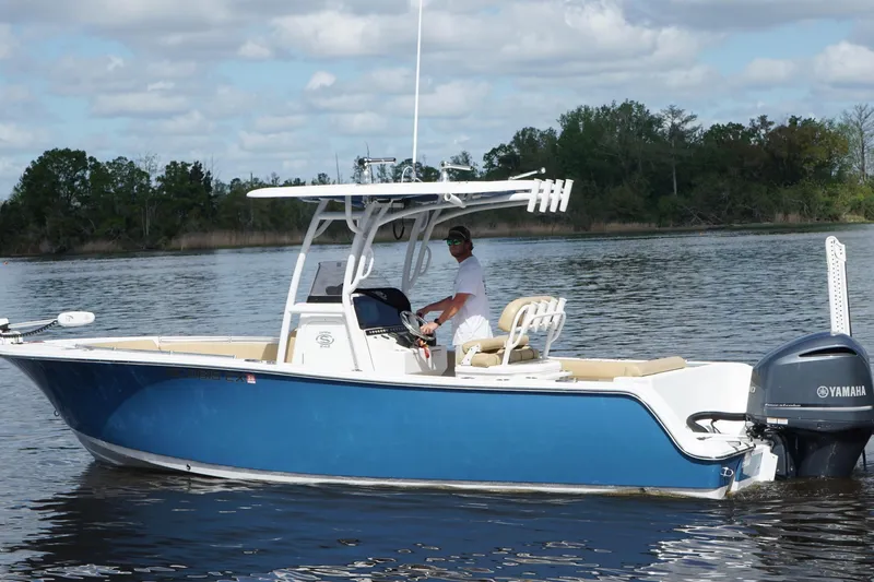 Slide: The Image of 2022 Sportsman Open 242 Center Console boat on calm water, featuring a Yamaha engine. - 8