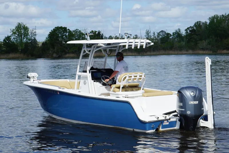 Slide: The Image of 2022 Sportsman Open 242 Center Console boat on calm water, featuring a Yamaha 300 engine. - 9